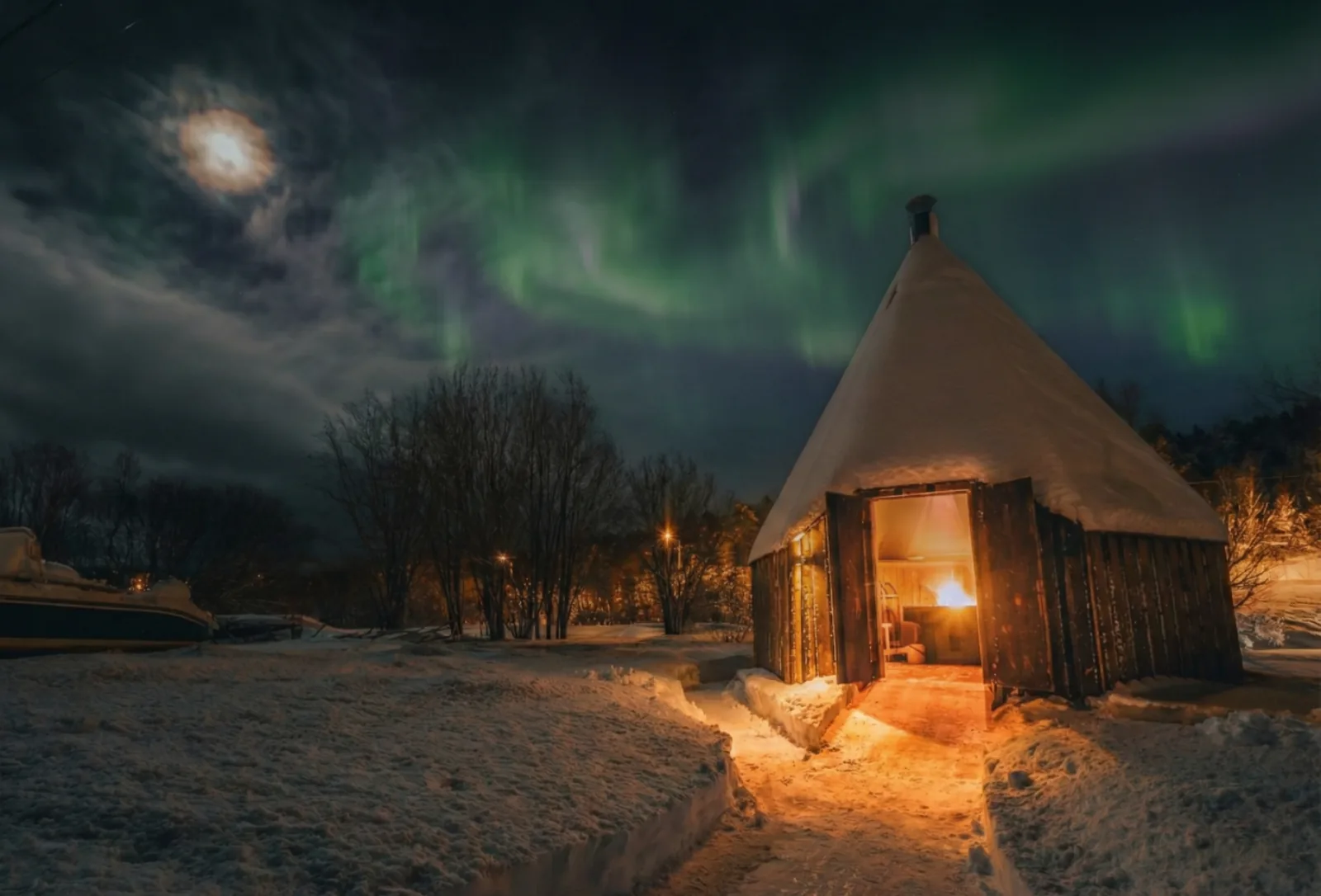 The shamanic lavvu lit from within on a winter night
